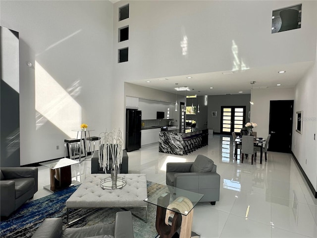 living room featuring a high ceiling and light tile patterned floors