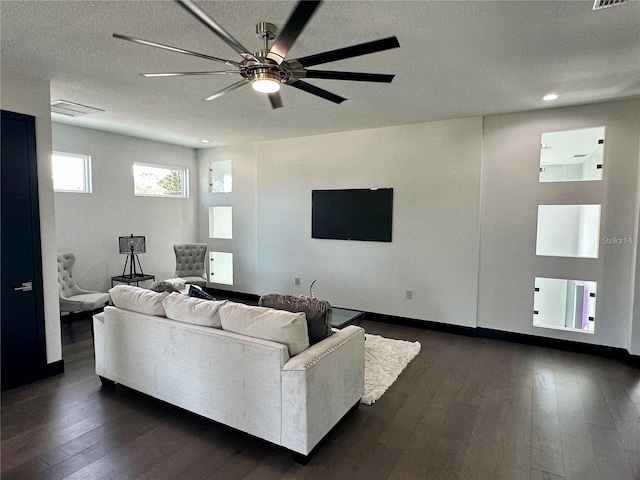 living room featuring a textured ceiling, dark hardwood / wood-style floors, and ceiling fan