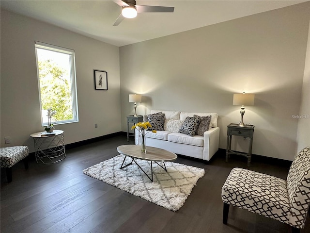 living room with dark wood-type flooring and ceiling fan