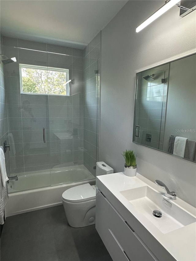 full bathroom featuring bath / shower combo with glass door, toilet, and vanity