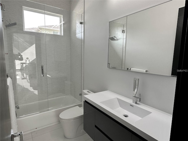 full bathroom featuring combined bath / shower with glass door, vanity, and toilet