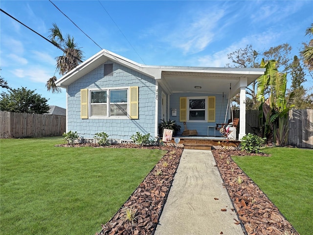 view of front of property with covered porch and a front yard