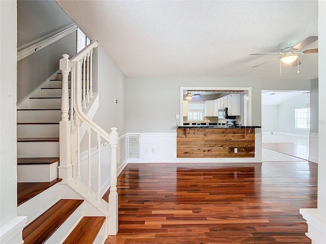 interior space with hardwood / wood-style floors, a textured ceiling, and a healthy amount of sunlight