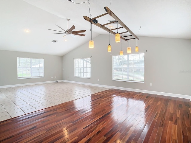 spare room with ceiling fan, wood-type flooring, and lofted ceiling