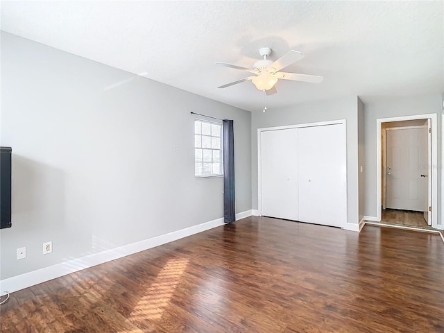 unfurnished bedroom featuring a closet, ceiling fan, and dark wood-type flooring