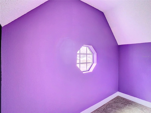 bonus room with a textured ceiling, carpet, and lofted ceiling