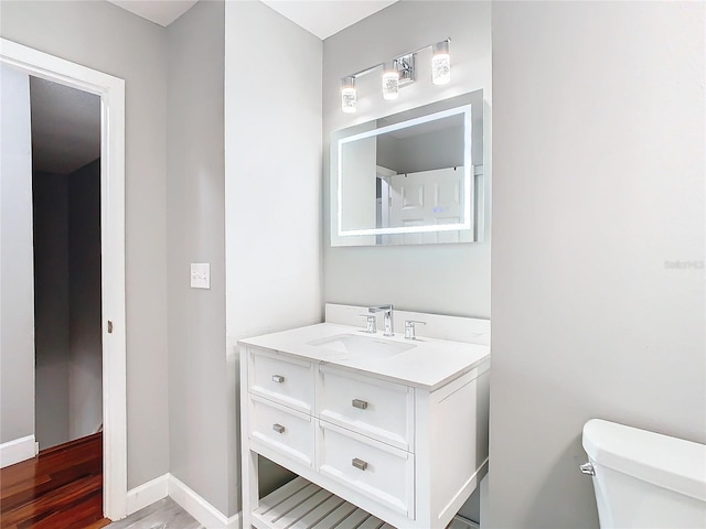 bathroom featuring vanity and toilet