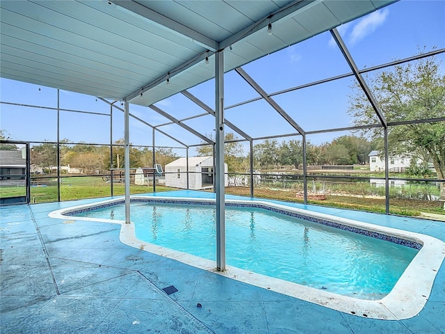 view of swimming pool featuring a patio area and a lanai