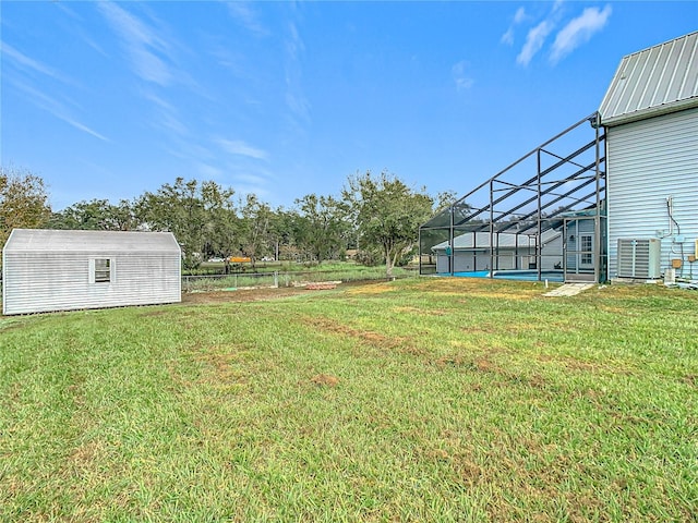 view of yard with glass enclosure and cooling unit