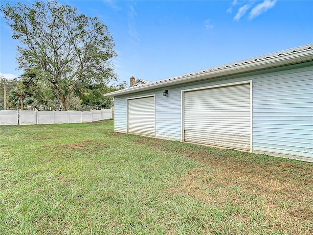 garage featuring a lawn