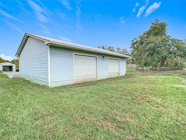 garage featuring a lawn