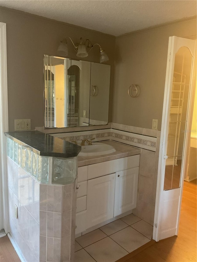 bathroom featuring vanity, a textured ceiling, and tile patterned floors