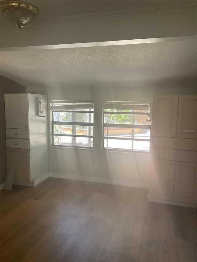 empty room featuring hardwood / wood-style floors and a textured ceiling