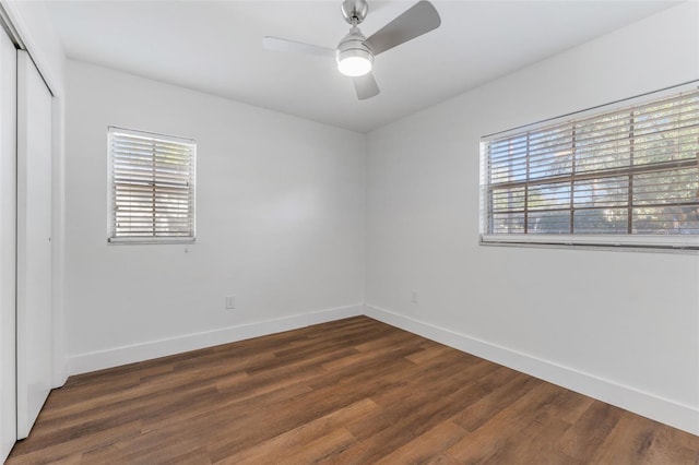 unfurnished room with dark wood-type flooring and ceiling fan