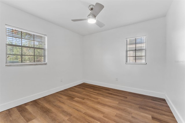 unfurnished room with hardwood / wood-style flooring and ceiling fan