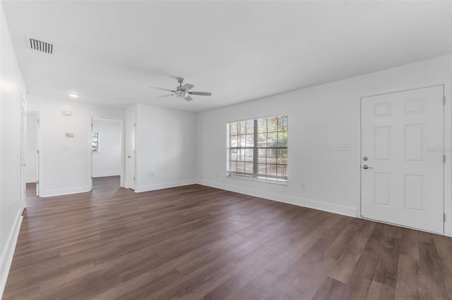 unfurnished living room with dark hardwood / wood-style floors and ceiling fan