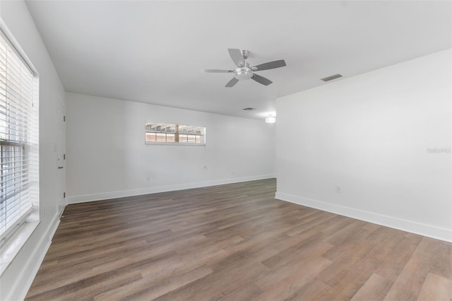 empty room with ceiling fan and hardwood / wood-style floors