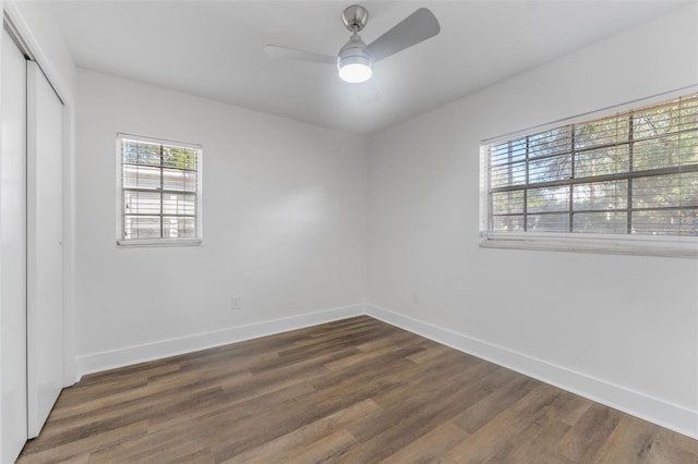 spare room featuring dark wood-type flooring and ceiling fan