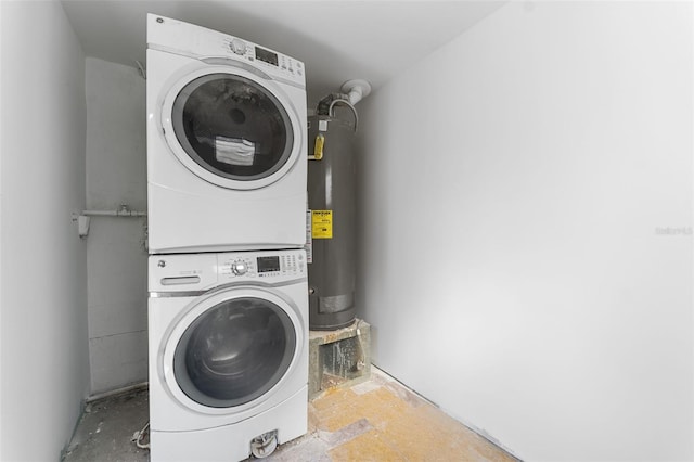 washroom with stacked washer / dryer and gas water heater