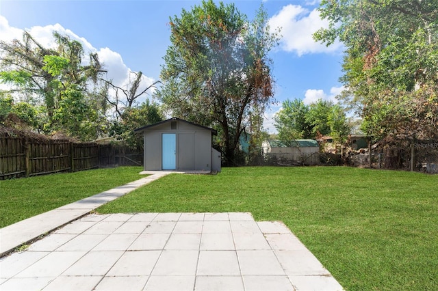 view of yard with a storage shed and a patio