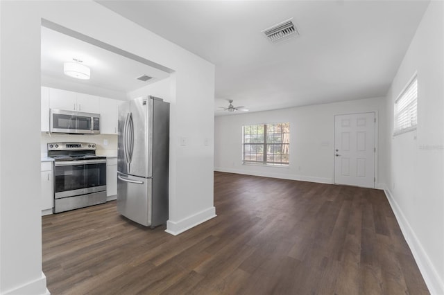 kitchen with appliances with stainless steel finishes, dark hardwood / wood-style floors, white cabinets, and ceiling fan