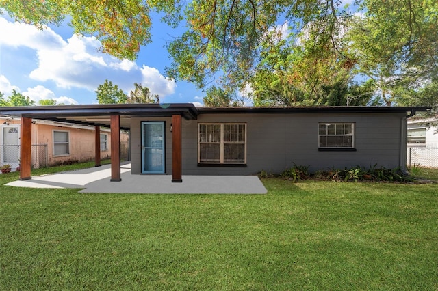 rear view of house with a yard and a patio area