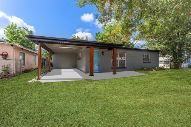 back of property featuring a patio area and a lawn