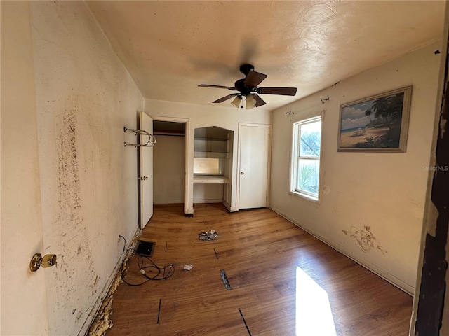 unfurnished bedroom with light hardwood / wood-style flooring and ceiling fan