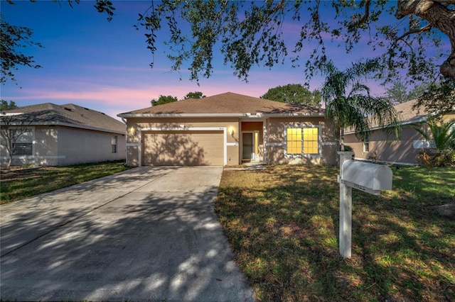 view of front of home featuring a yard and a garage