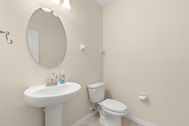 bathroom with tile patterned flooring, toilet, and sink