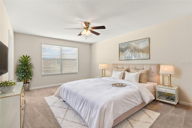 bedroom featuring light carpet and ceiling fan