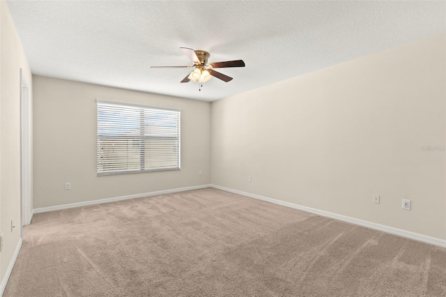 carpeted empty room featuring a textured ceiling and ceiling fan