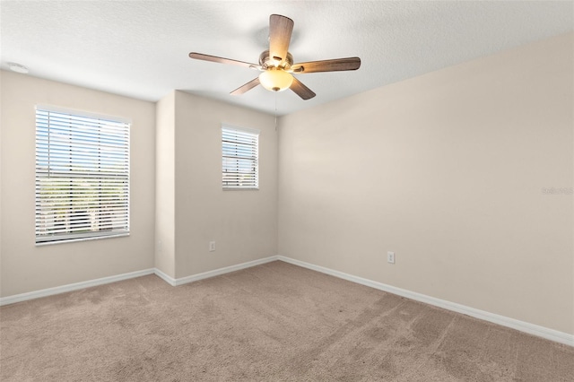 spare room with light colored carpet and ceiling fan