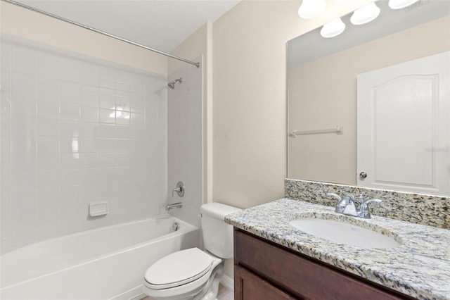 full bathroom with vanity, tiled shower / bath combo, and toilet