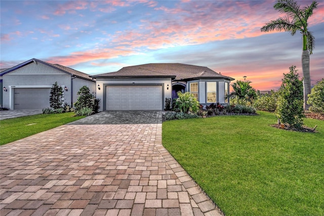 single story home with a lawn and a garage