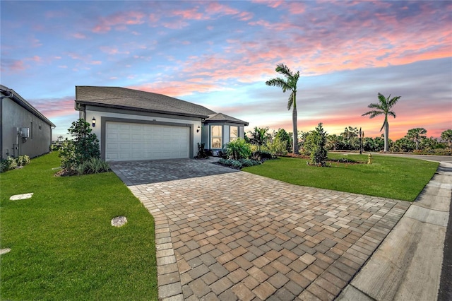 view of front of house with a lawn and a garage