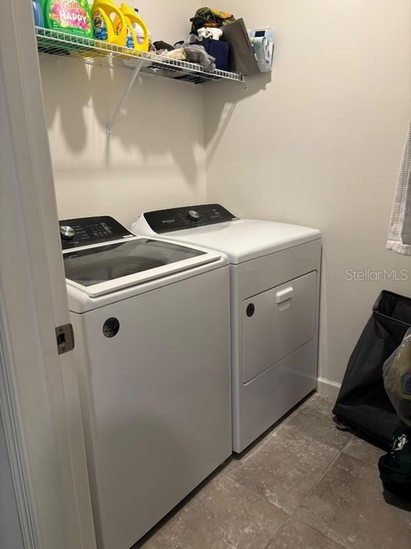 clothes washing area with independent washer and dryer