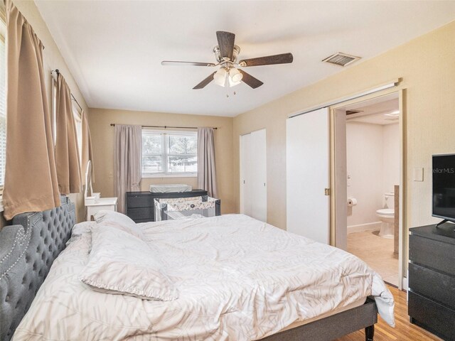 bedroom with a closet, ceiling fan, light hardwood / wood-style flooring, and ensuite bathroom