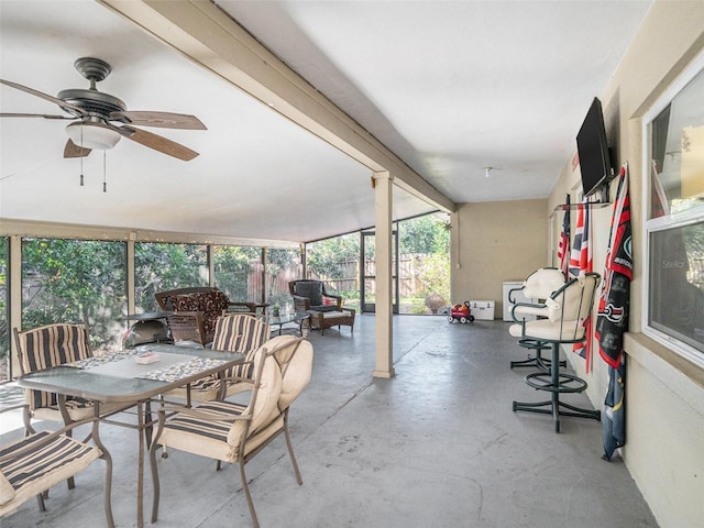 sunroom featuring ceiling fan