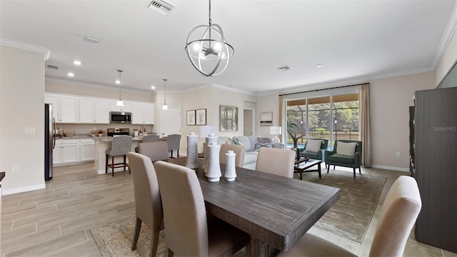 dining room with a notable chandelier and crown molding