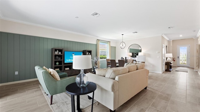 living room with a chandelier and crown molding