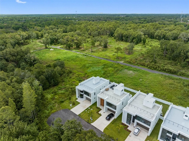 birds eye view of property featuring a view of trees