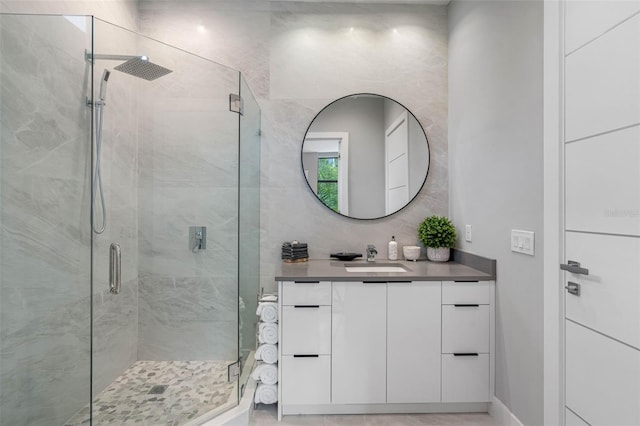 full bath featuring a stall shower and vanity