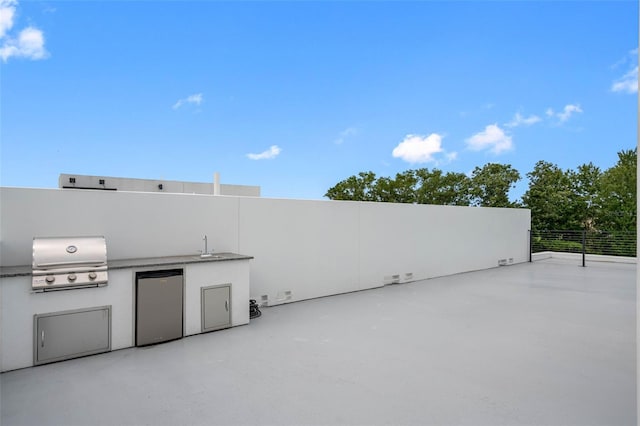 view of patio / terrace featuring exterior kitchen, area for grilling, and a sink