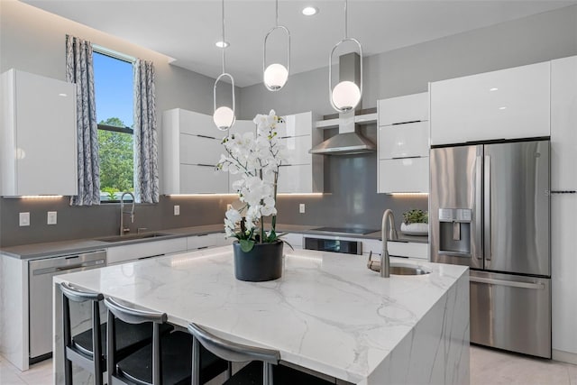 kitchen featuring modern cabinets, a sink, stainless steel fridge, white cabinets, and dishwasher