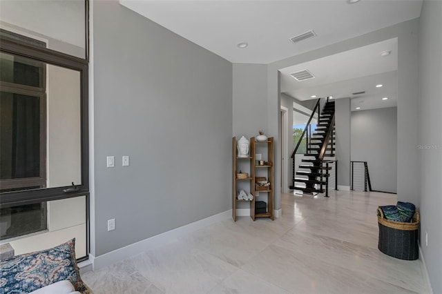 interior space with stairway, recessed lighting, baseboards, and visible vents