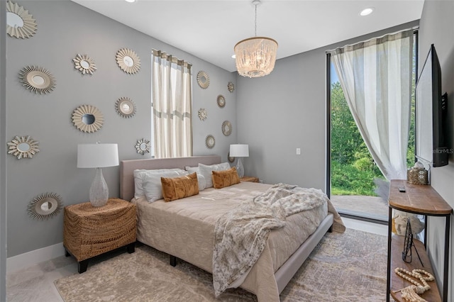 bedroom with access to exterior, recessed lighting, an inviting chandelier, and baseboards