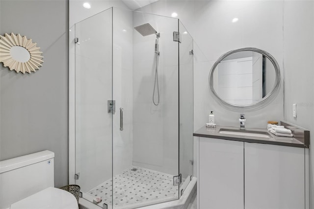 full bathroom with a stall shower, toilet, and vanity