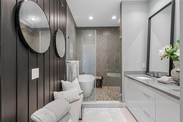 full bathroom featuring a soaking tub, recessed lighting, a shower stall, and vanity