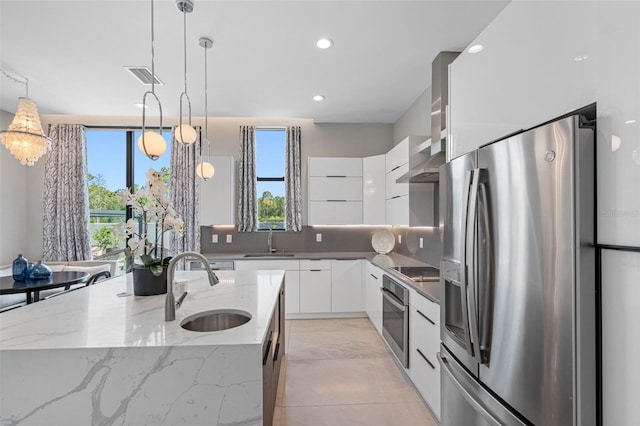 kitchen featuring visible vents, a sink, appliances with stainless steel finishes, white cabinetry, and modern cabinets